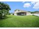 Large backyard with screened patio and lush grass at 1704 Cresswell Manor Ct, Dover, FL 33527