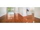 Spacious living room with gleaming hardwood floors and access to the backyard at 1704 Cresswell Manor Ct, Dover, FL 33527
