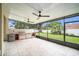 Outdoor kitchen with built-in grill and screened enclosure at 1704 Cresswell Manor Ct, Dover, FL 33527