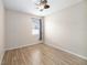 Spacious bedroom with ceiling fan and wood-look floors at 1704 Cresswell Manor Ct, Dover, FL 33527
