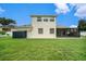 House exterior showcasing backyard and screened patio at 1704 Cresswell Manor Ct, Dover, FL 33527