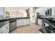 Modern kitchen with stainless steel appliances and dark granite countertops at 1704 Cresswell Manor Ct, Dover, FL 33527