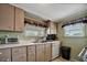 Efficient kitchen with light-colored cabinets, stainless steel sink, and modern appliances at 122 E Saint Annes Cir, Apollo Beach, FL 33572