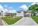 Single-wide manufactured home with carport, landscaping, and paved driveway at 122 E Saint Annes Cir, Apollo Beach, FL 33572