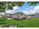 Mobile home with covered patio, kayak storage, and large backyard at 122 E Saint Annes Cir, Apollo Beach, FL 33572