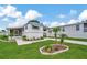 Landscaped manufactured home with a covered porch and spacious yard at 122 E Saint Annes Cir, Apollo Beach, FL 33572
