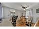 Small dining area with glass table and four chairs, view to kitchen at 122 E Saint Annes Cir, Apollo Beach, FL 33572
