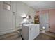 Functional laundry room with washer, dryer, and extra storage at 122 E Saint Annes Cir, Apollo Beach, FL 33572