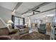 Spacious living room featuring a ceiling fan, comfy seating, and a large TV at 122 E Saint Annes Cir, Apollo Beach, FL 33572