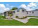 Well-maintained manufactured home with attractive landscaping and a paved driveway at 122 E Saint Annes Cir, Apollo Beach, FL 33572