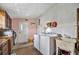 Laundry room features washer, dryer, utility sink, and cabinets at 122 E Saint Annes Cir, Apollo Beach, FL 33572