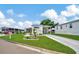 Charming mobile home with carport and landscaped front yard at 122 E Saint Annes Cir, Apollo Beach, FL 33572