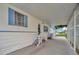 Covered patio with access to the home and additional storage at 122 E Saint Annes Cir, Apollo Beach, FL 33572