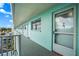 Exterior view of a light teal building with a walkway, railings, and individual apartment doors at 1819 Shore S Dr # 318, South Pasadena, FL 33707