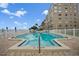 Inviting community swimming pool with surrounding patio at 1819 Shore S Dr # 318, South Pasadena, FL 33707