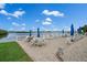 Relaxing waterfront patio area with tables and lounge chairs at 1819 Shore S Dr # 318, South Pasadena, FL 33707