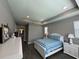 Main bedroom with white dresser and ensuite bathroom at 5776 Newberry Pines Ave, Wesley Chapel, FL 33545