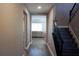 Long hallway with wood-look tile flooring and staircase at 5776 Newberry Pines Ave, Wesley Chapel, FL 33545