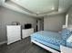Spacious bedroom with white dresser and ensuite bathroom at 5776 Newberry Pines Ave, Wesley Chapel, FL 33545