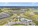 Aerial view of a community with pools, playground, and houses at 5776 Newberry Pines Ave, Wesley Chapel, FL 33545