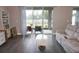 Living room with sliding glass doors to backyard and large sectional sofa at 5776 Newberry Pines Ave, Wesley Chapel, FL 33545