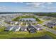 Aerial view of houses surrounding a lake at 5776 Newberry Pines Ave, Wesley Chapel, FL 33545