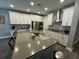 Modern kitchen with white cabinets, stainless steel appliances, and large island at 5776 Newberry Pines Ave, Wesley Chapel, FL 33545