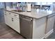 Kitchen island with sink, dishwasher, and ample counter space at 5776 Newberry Pines Ave, Wesley Chapel, FL 33545