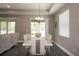 Spacious dining area with six chairs and access to backyard at 5776 Newberry Pines Ave, Wesley Chapel, FL 33545