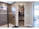 Bathroom with walk-in shower, walk-in closet, and modern vanity at 5776 Newberry Pines Ave, Wesley Chapel, FL 33545
