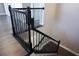 Elegant staircase with dark wood railings and metal accents at 5776 Newberry Pines Ave, Wesley Chapel, FL 33545