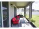 Relaxing screened porch with comfortable seating and a view of the backyard at 5776 Newberry Pines Ave, Wesley Chapel, FL 33545