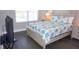 Bedroom with large window, hardwood floors, and TV at 5776 Newberry Pines Ave, Wesley Chapel, FL 33545