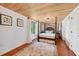 Charming bedroom with wood floors, brick accent wall, and a four-poster bed at 608 Armada S Rd, Venice, FL 34285