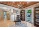 Home office with brick wall, hardwood floors, and access to backyard at 608 Armada S Rd, Venice, FL 34285