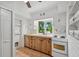 Small kitchen with white appliances and wood cabinets at 608 Armada S Rd, Venice, FL 34285