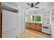 Efficient kitchen featuring white appliances and wood cabinets at 608 Armada S Rd, Venice, FL 34285