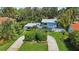 Aerial view of house with circular driveway and lush landscaping at 608 Armada S Rd, Venice, FL 34285