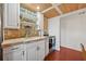 Charming kitchen with white cabinets, stone countertops, and mosaic backsplash at 608 Armada S Rd, Venice, FL 34285