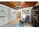 Bright home office with hardwood floors, chandelier, and built-in shelving at 608 Armada S Rd, Venice, FL 34285
