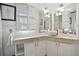 Elegant bathroom with double vanity, updated fixtures, and decorative shutters at 608 Armada S Rd, Venice, FL 34285