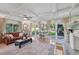 Spacious living room with fireplace and garden access at 608 Armada S Rd, Venice, FL 34285