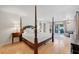 Luxurious main bedroom with king-size bed and access to patio at 608 Armada S Rd, Venice, FL 34285