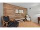 Cozy sitting area with wood-paneled accent wall and comfortable seating at 608 Armada S Rd, Venice, FL 34285