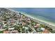 Aerial view of coastal community showcasing beach, homes, and lush landscaping at 608 Armada S Rd, Venice, FL 34285