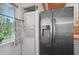 Compact laundry room with stackable washer and dryer, and a window at 608 Armada S Rd, Venice, FL 34285