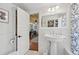 Classic bathroom with pedestal sink, white subway tile, and patterned shower curtain at 608 Armada S Rd, Venice, FL 34285