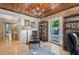 Home office with brick wall, hardwood floors, and access to backyard at 608 Armada S Rd, Venice, FL 34285