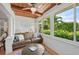 Sunroom with a leather sofa and wooden ceiling at 608 Armada S Rd, Venice, FL 34285