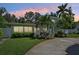 House exterior at dusk with landscaping and driveway at 608 Armada S Rd, Venice, FL 34285